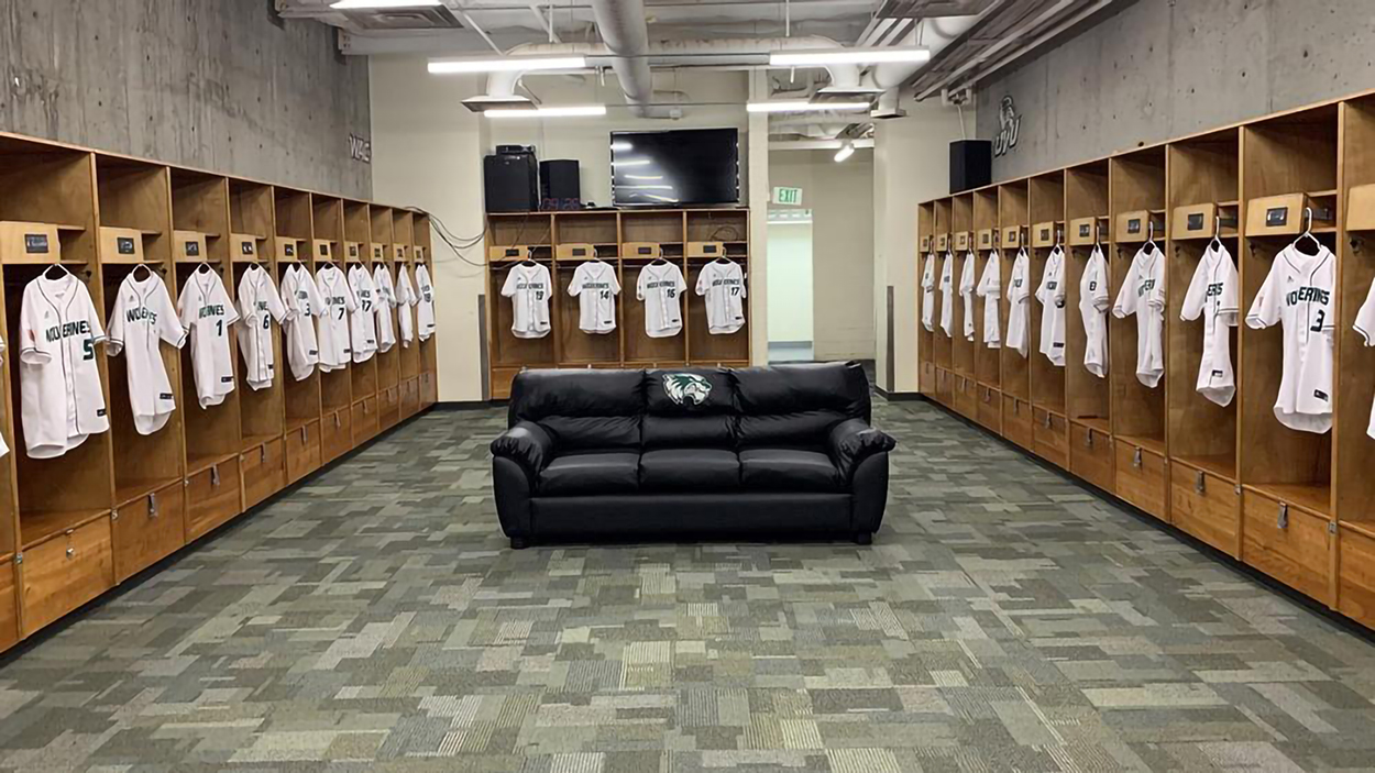 Interior image in the locker room with all the players jerseys hanging up. 
